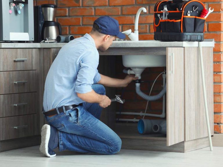 A handyman performing common tasks like fixing a faucet, repairing drywall, and installing shelves