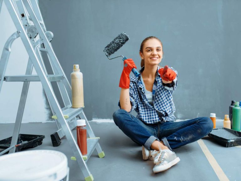 A homeowner wearing safety gear while performing a home repair.