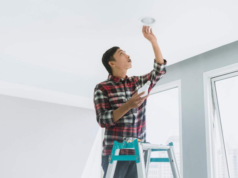 Handyman installing energy-efficient lighting in a home