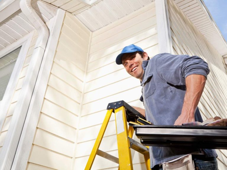 Handyman working on home repairs to prepare a house for sale