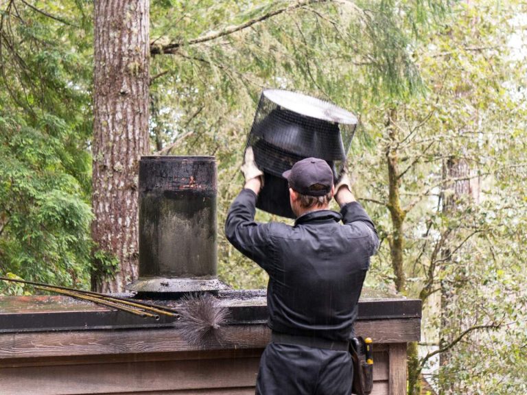 A chimney sweep cleaning a brick chimney, ensuring the chimney is free of creosote buildup and maintaining fireplace safety.