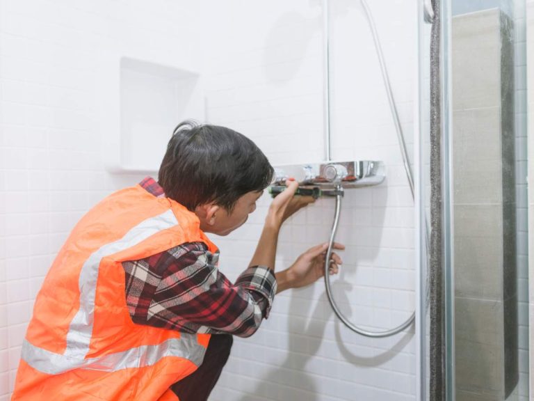 A handyman performing maintenance work in a residential property, assisting in property management tasks
