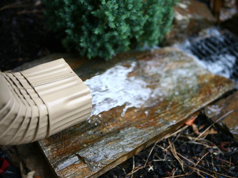 Properly installed gutters channeling rainwater away from a home's foundation to prevent erosion and water damage.