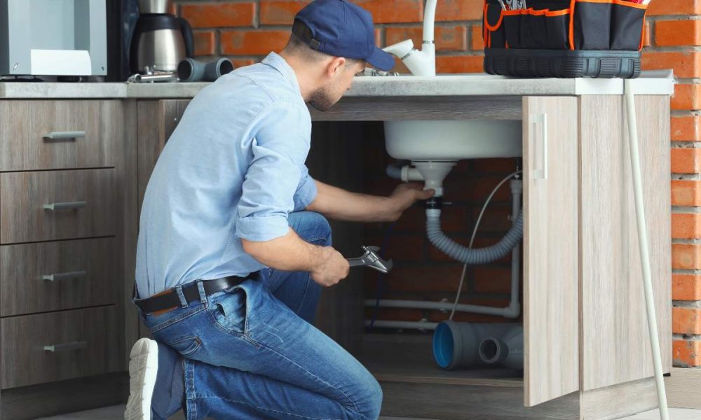 A handyman performing common tasks like fixing a faucet, repairing drywall, and installing shelves